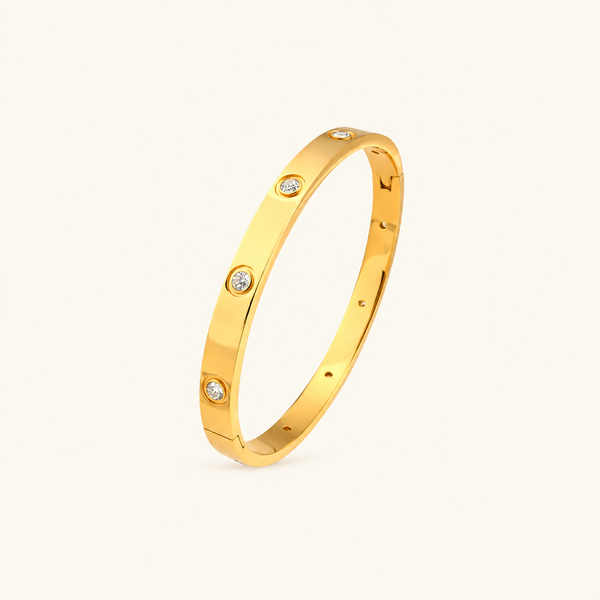 Adorned Bangle in gold with crystal insets on warm ivory background