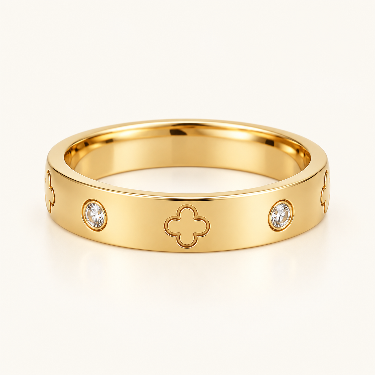 Gold Clover Zircon Ring on a warm ivory background