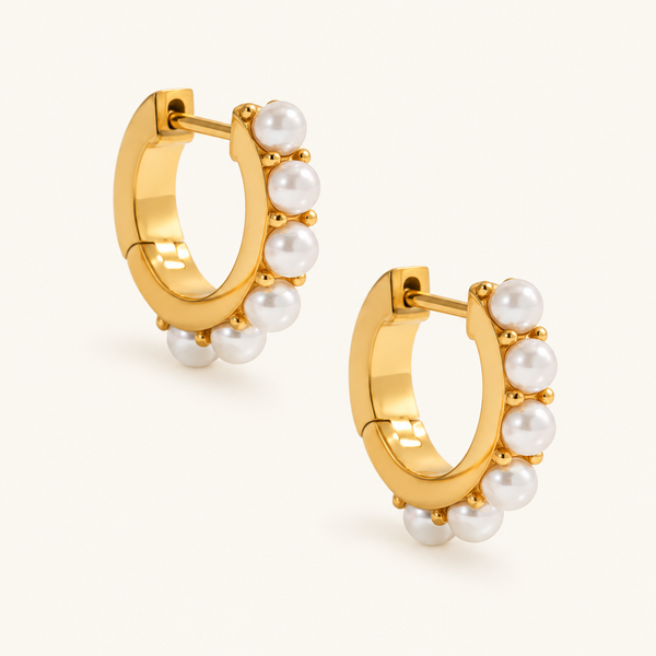 Golden Pearl Rim Hoops with white pearl details along gold-tone rims, arranged diagonally on an ivory background