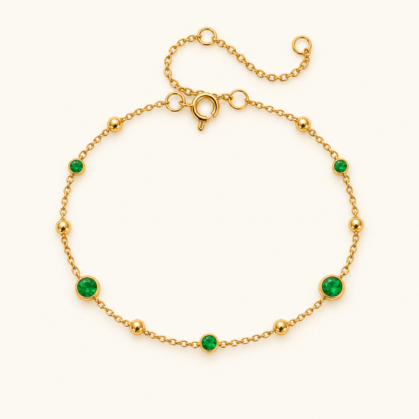 Green dot bracelet with five green stones and gold beads on a delicate gold-tone chain