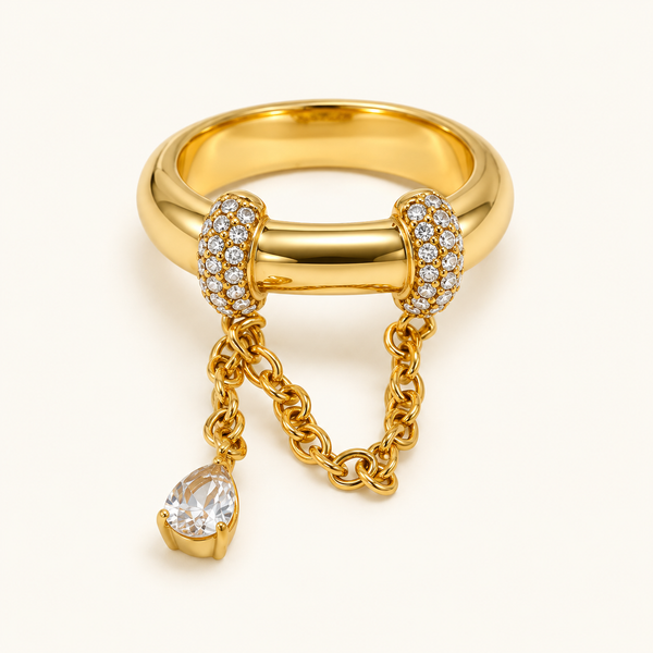 Gold Tassel Ring with zircon details on a warm ivory background