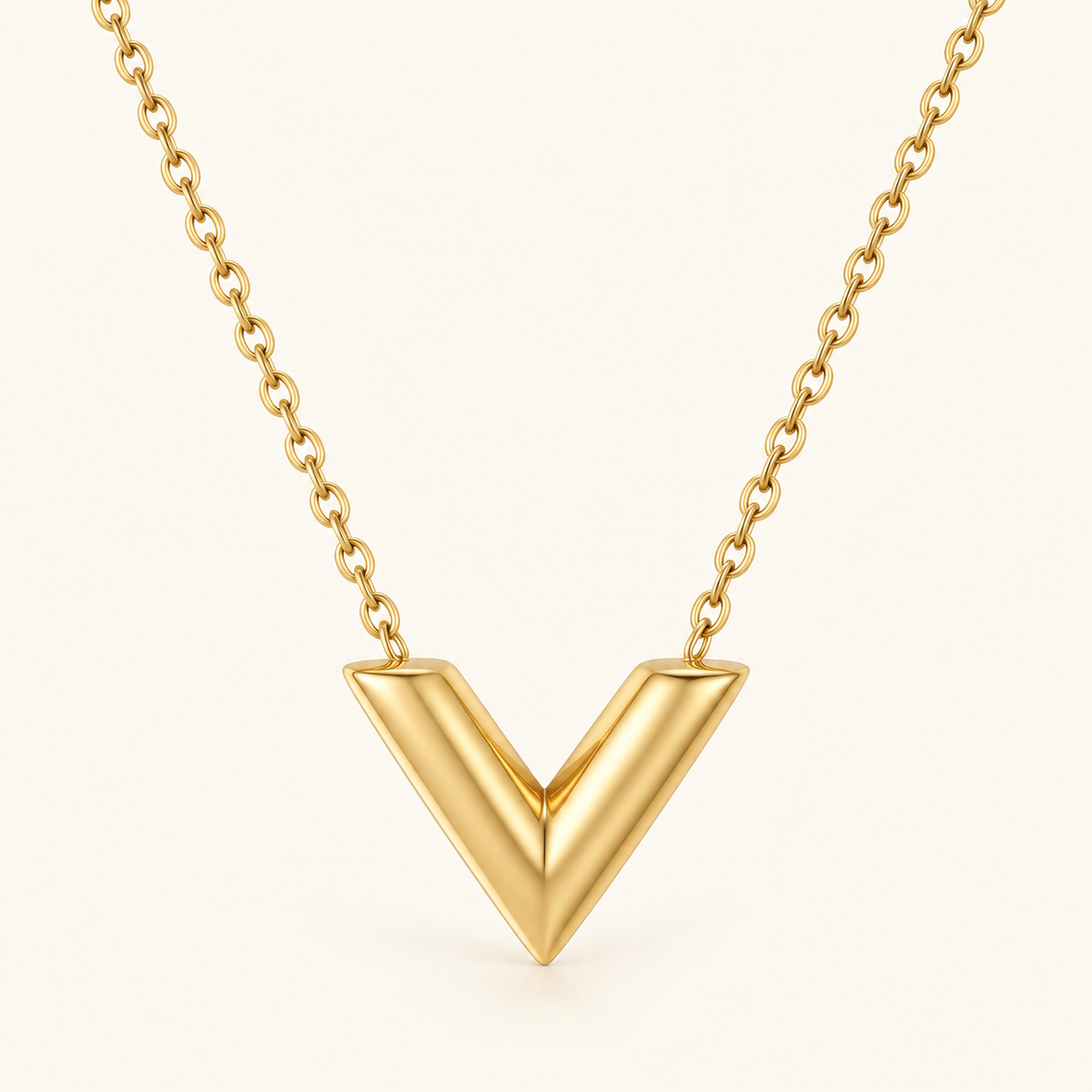 Gold V-Shape Necklace on a warm ivory background