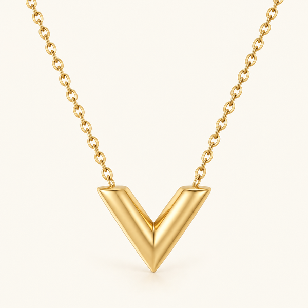 Gold V-Shape Necklace on a warm ivory background